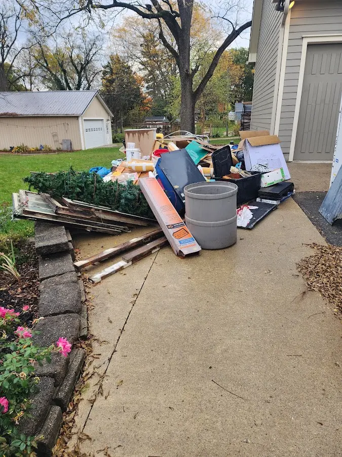 Dumpster being loaded with debris for Estate Cleanout Dumpster Rental in Treasure Island